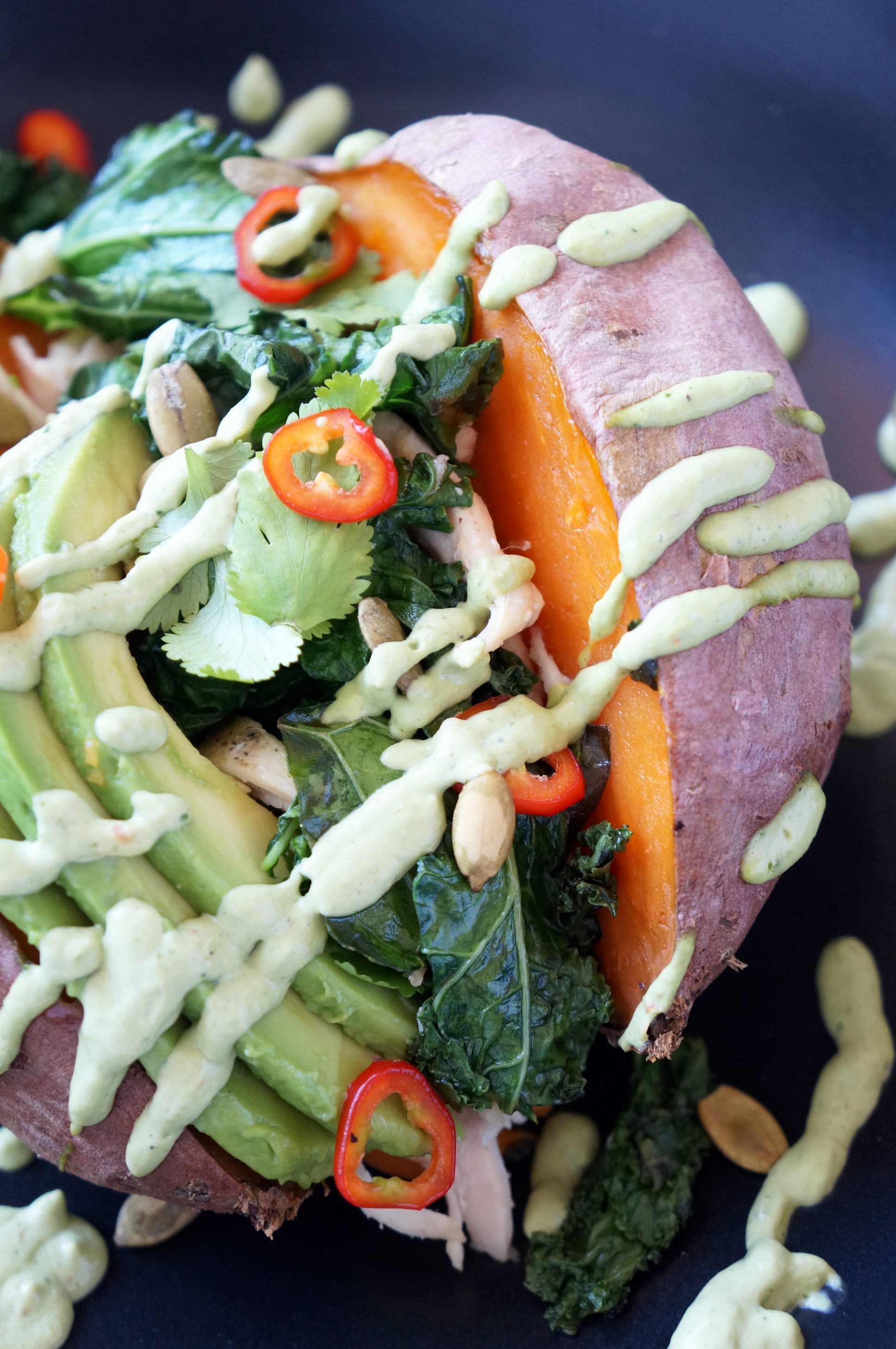 Loaded Sweet Potato with cilantro lime sauce, kale, chicken, avocado